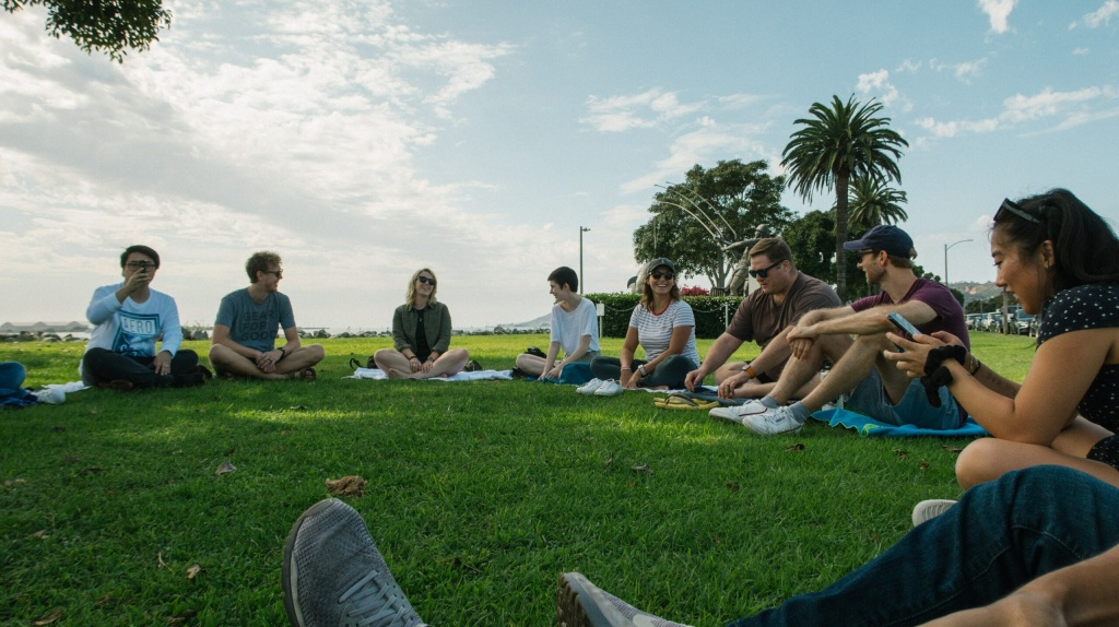 a group of people outside on a green lawn