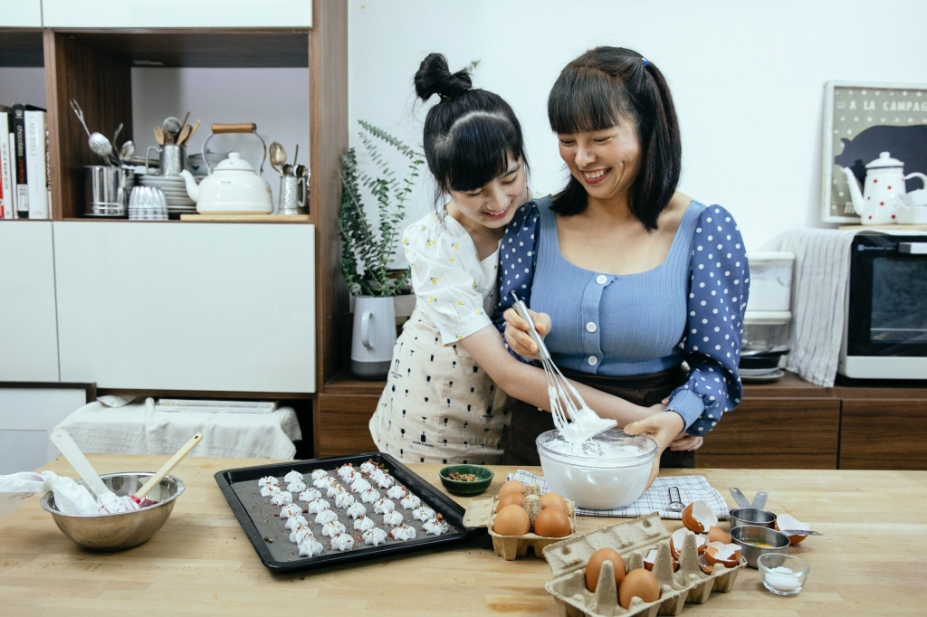 a mother and her teen daughter preparing a meal