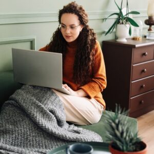 Woman on the couch in an article about online therapy for eating disorder treatment in Manhattan NYC.