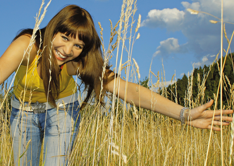 girl in high grass on a sunny day. self-compassion